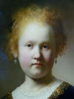rembrandtcloseupportraitofagirlwearingagoldtrimmedcloak.jpg