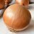 an unpeeled onion